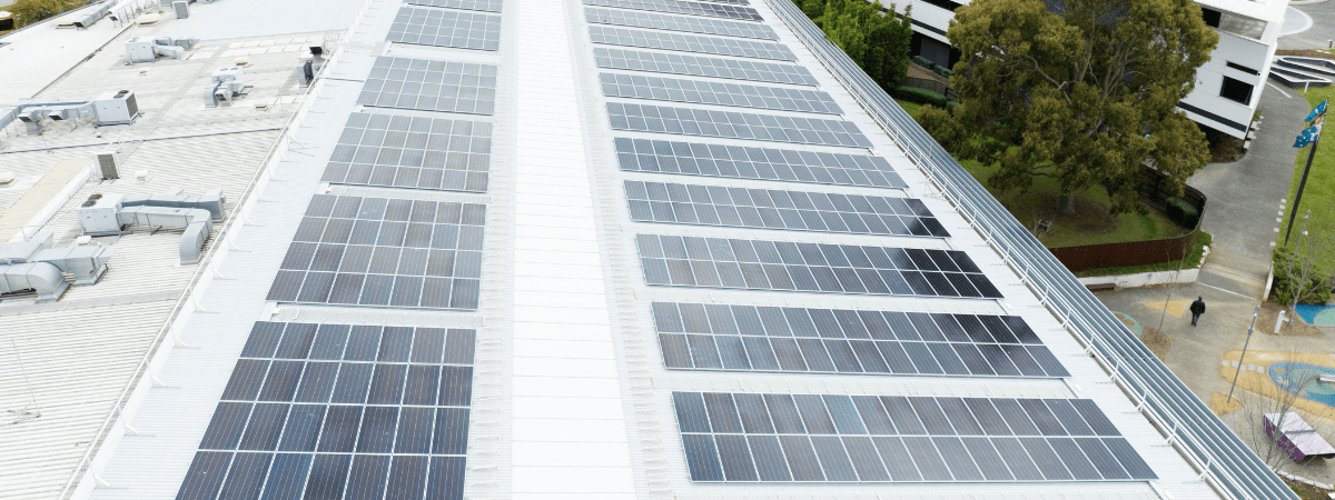 large roof with banks of solar panels 