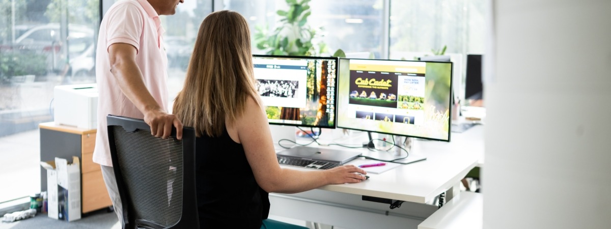 Man and woman looking at the computer screen.